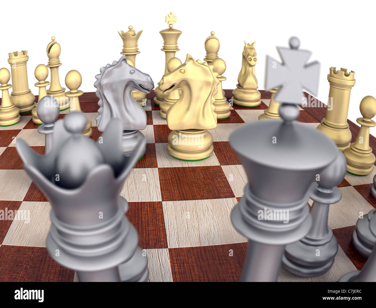 Close-Up of a metal chess set on a wooden board, isolated over white with knights confronting. Stock Photo