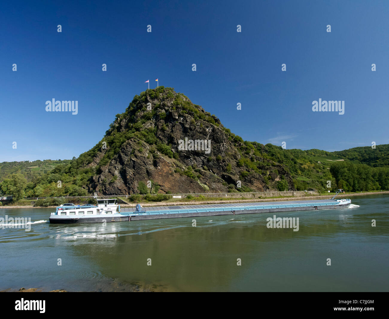 Large barge passes Loreley rock on River Rhine in Germany Stock Photo