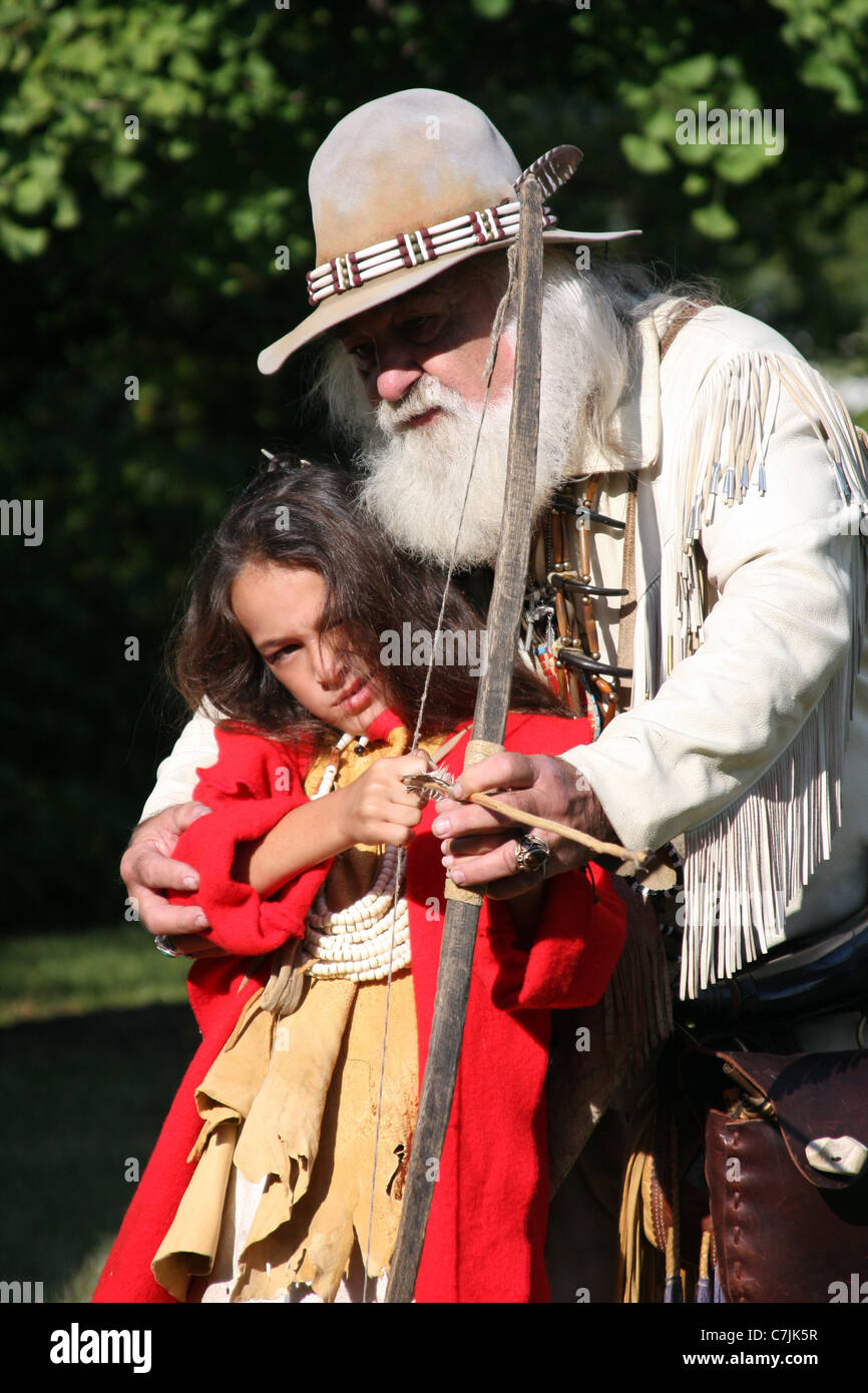 Mountain Man father figure showing young Native American Indian boy how ...