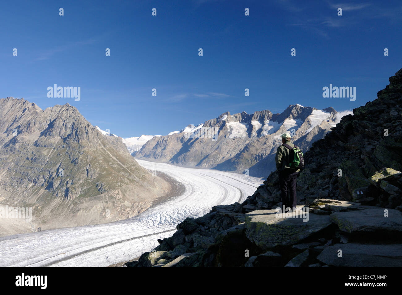 Switzerland, Aletsch Glacier (UNESCO world heritage site) nr. Bettmerhorn. Tourist at the start of the panorama trail. Stock Photo