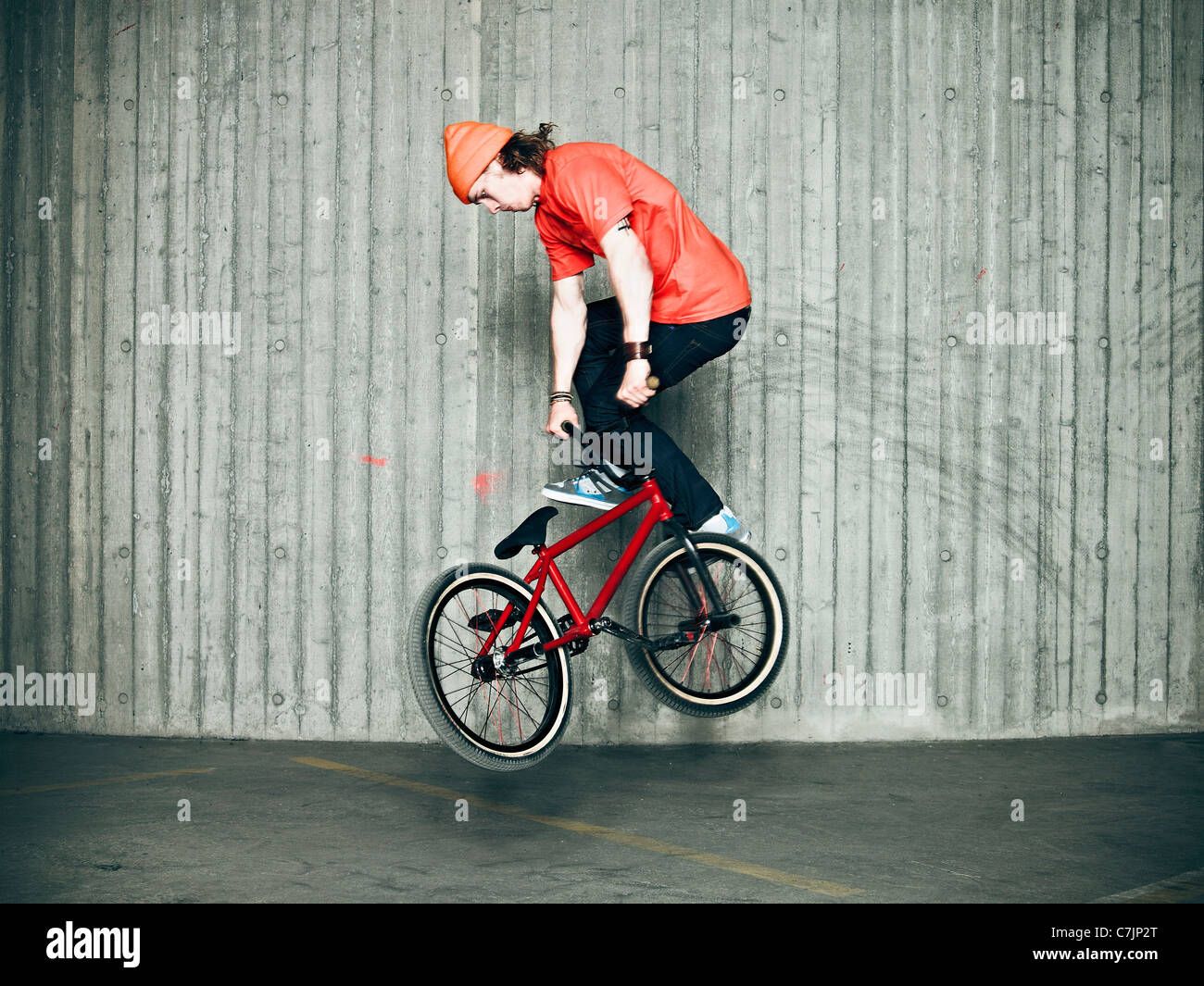 Man doing tricks on bmx bike indoors Stock Photo