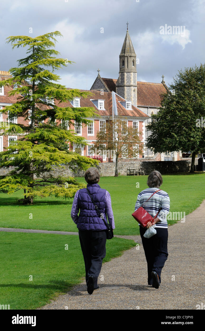 Visitors walking close to Sarum College The Close Salisbury Wiltshire England a Christian educational centre Stock Photo