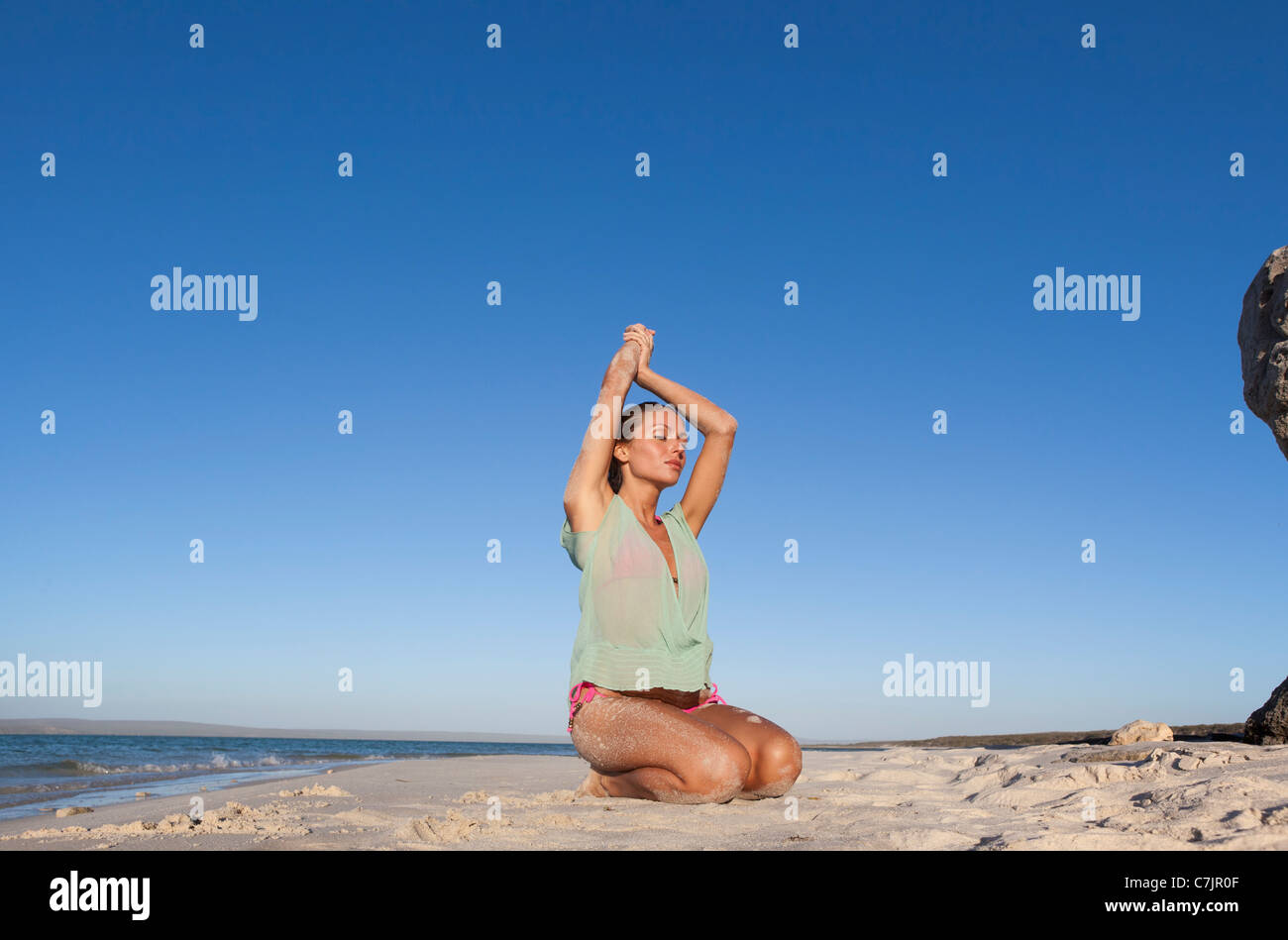 Woman in bikini kneeling on hi-res stock photography and images - Alamy