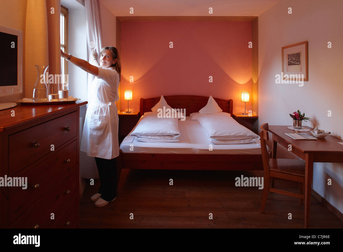 Maid cleaning hotel room Stock Photo