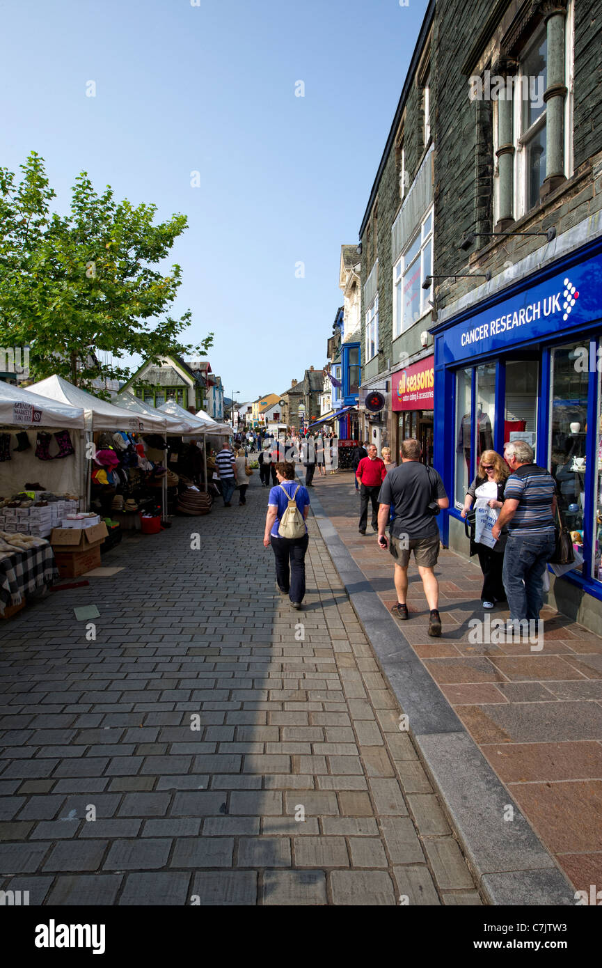 Tourists in the open air market in Main Street, Keswick in the Lake District, Cumbria, England Stock Photo