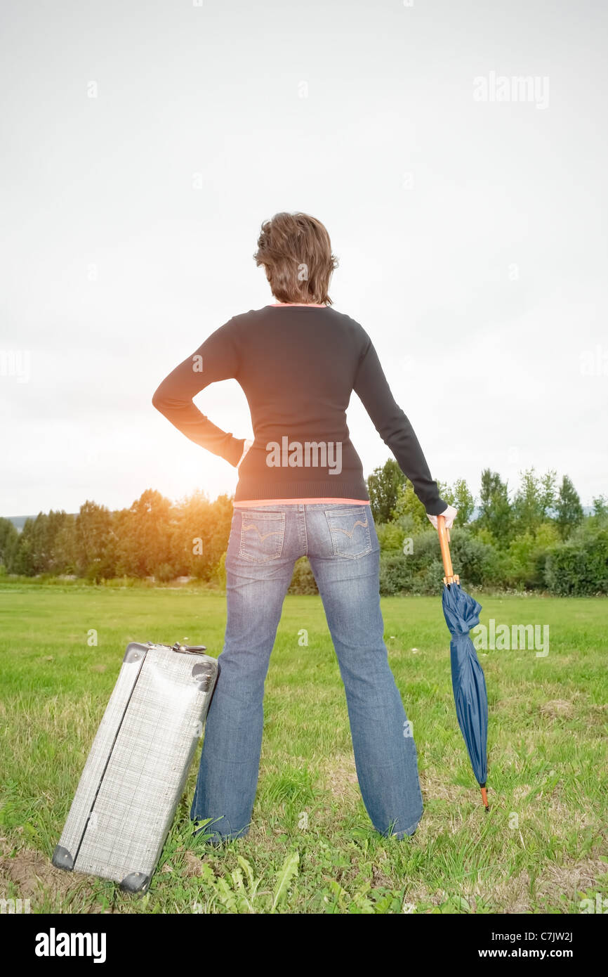 Rear view of a young woman standing on a meadow Stock Photo - Alamy