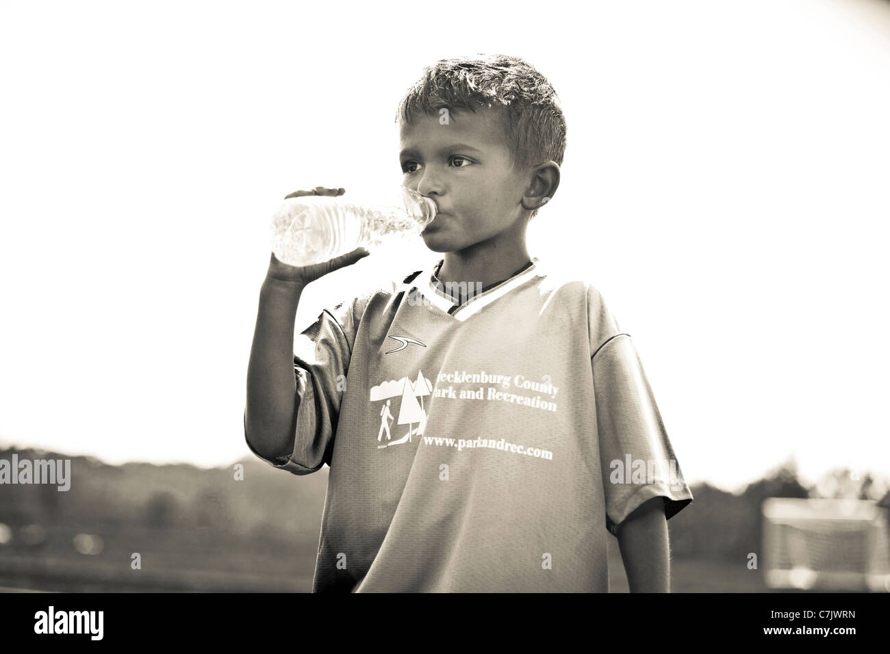 portrait of boy drinking bottled water Stock Photo