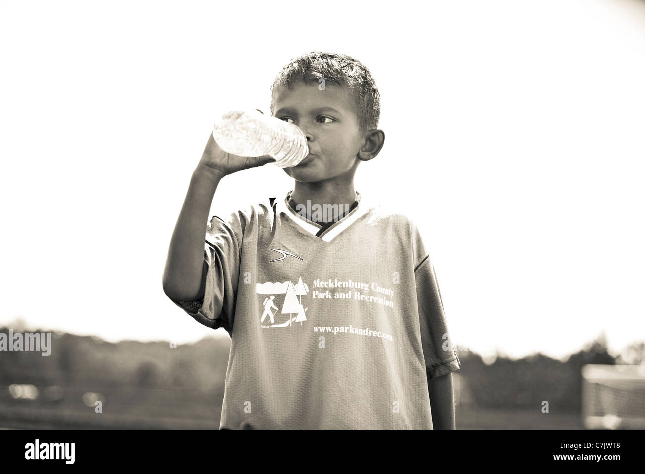 portrait of boy drinking bottled water Stock Photo
