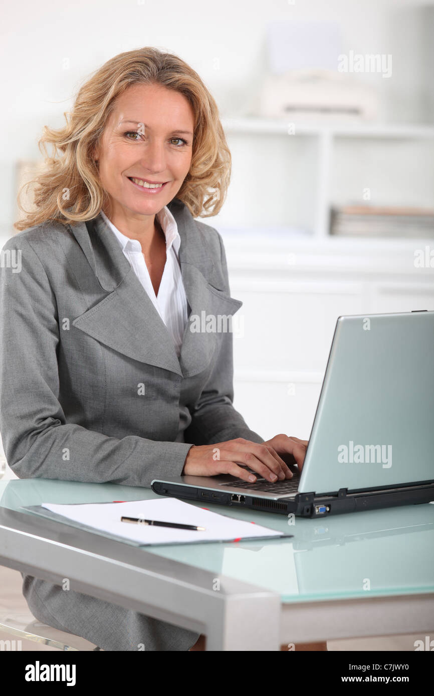 Female executive at laptop computer Stock Photo - Alamy