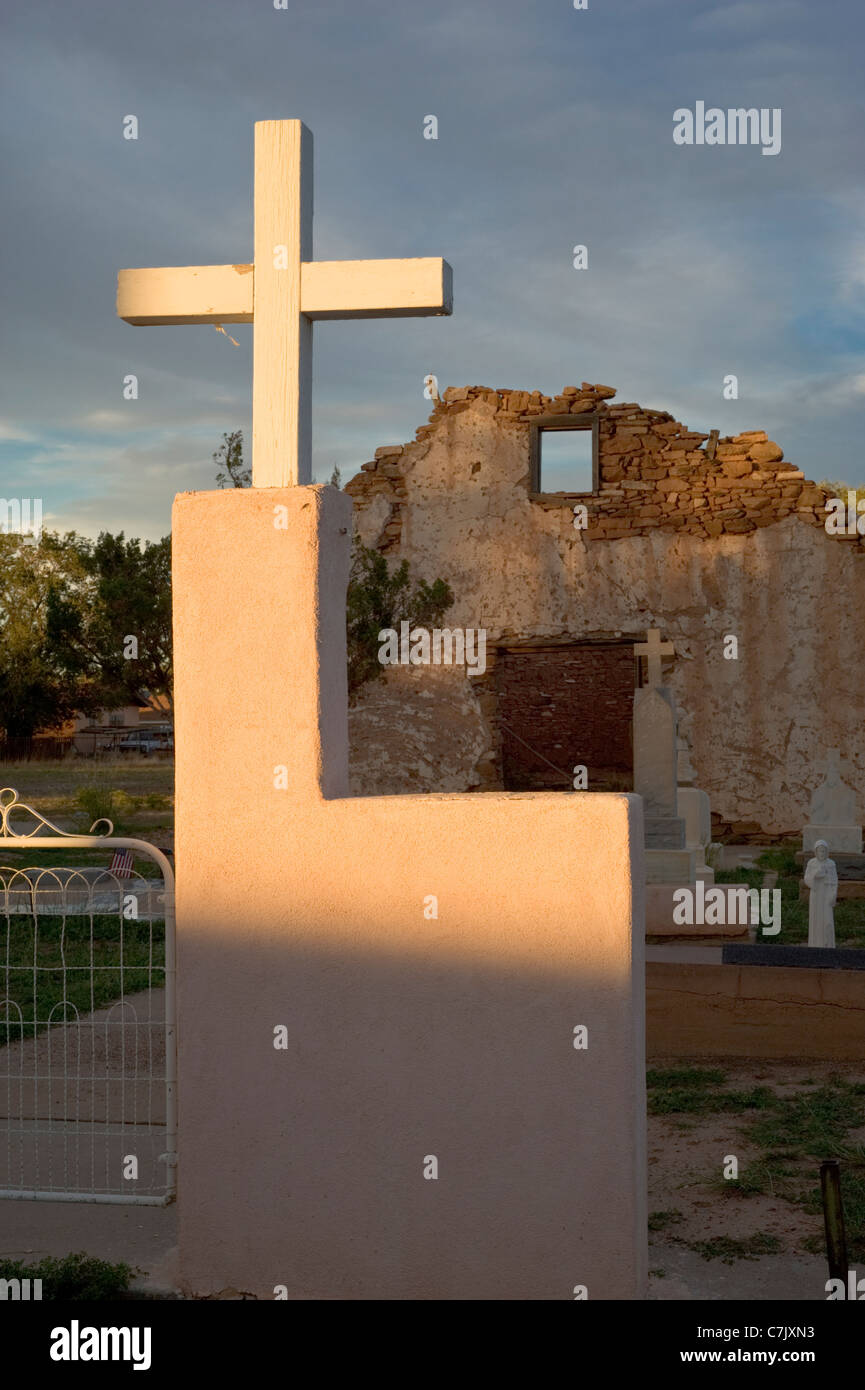 The adobe Saint Rose of Lima Chapel and cemetery, built in the early 1800's, glows in the setting sun in Santa Rosa, New Mexico. Stock Photo