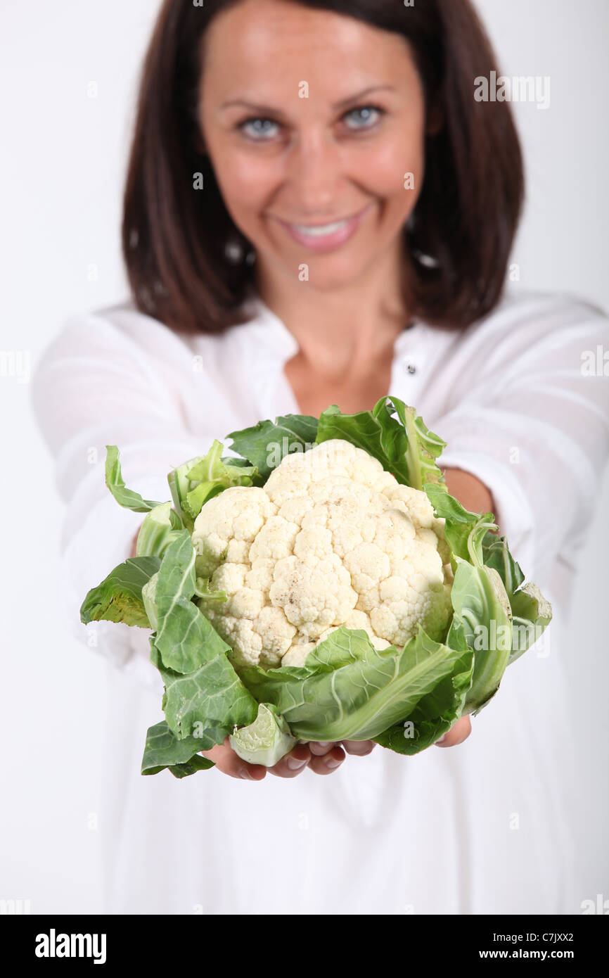 Woman proffering a whole cauliflower Stock Photo Alamy