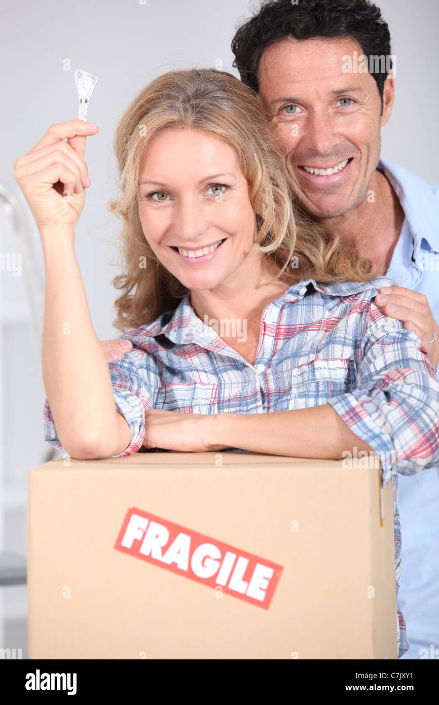 Couple with the key to their new home Stock Photo - Alamy
