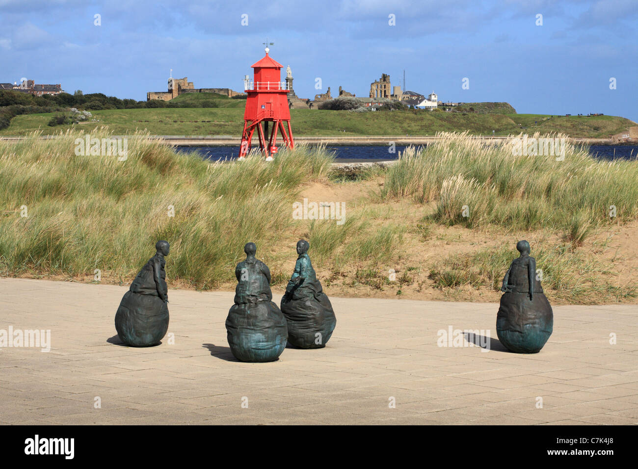 Conversation Piece sculptures and Groyne lighthouse South Shields, North East England, UK Stock Photo