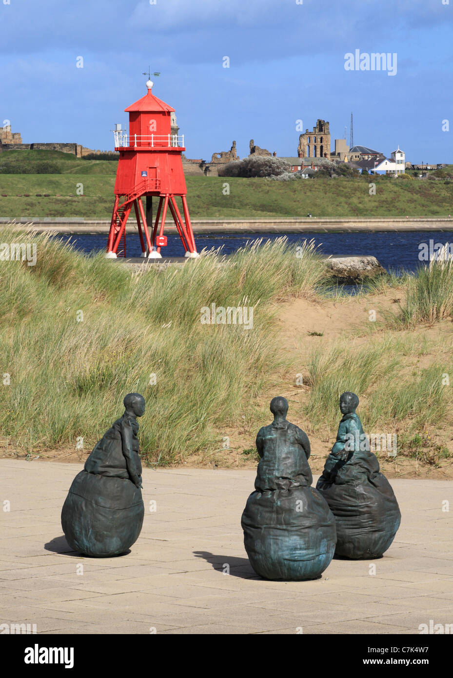 Conversation Piece sculpture and Groyne lighthouse South Shields, North East England, UK Stock Photo