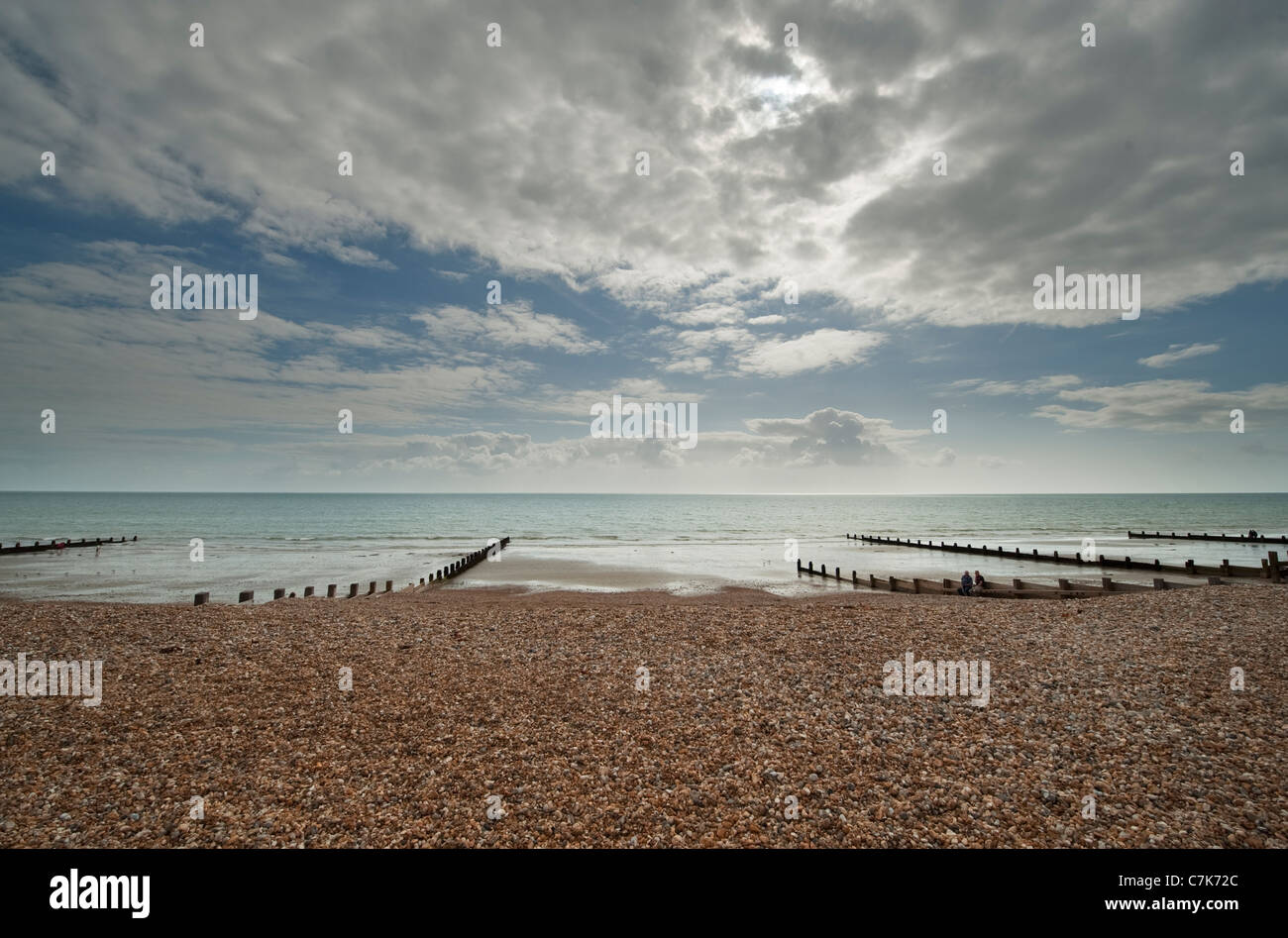 The shingle beach on the seafront at Bognor Regis at low tide, West Sussex, England with dramatic sky. Stock Photo