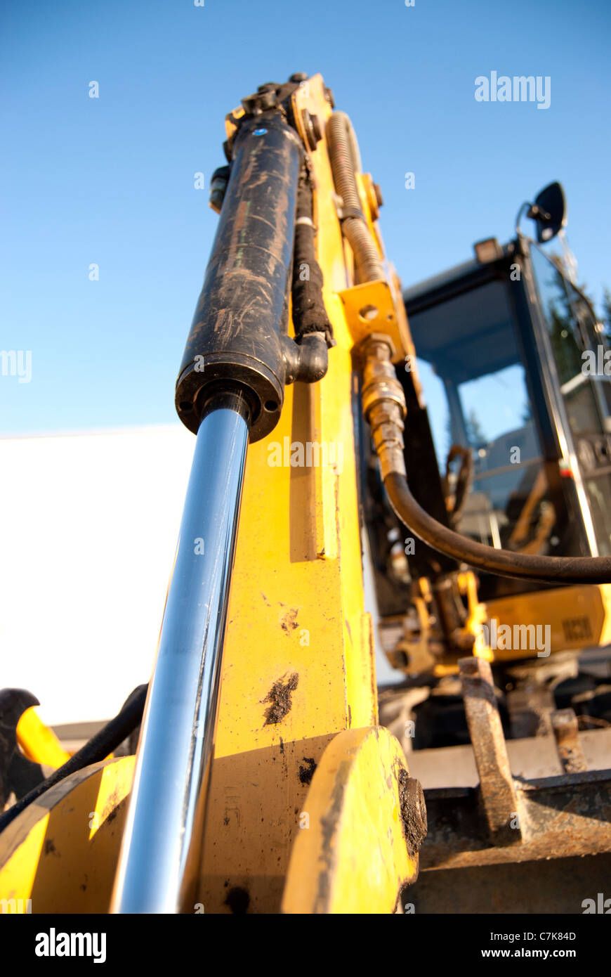 Excavator arm on building site a sunny day Stock Photo - Alamy