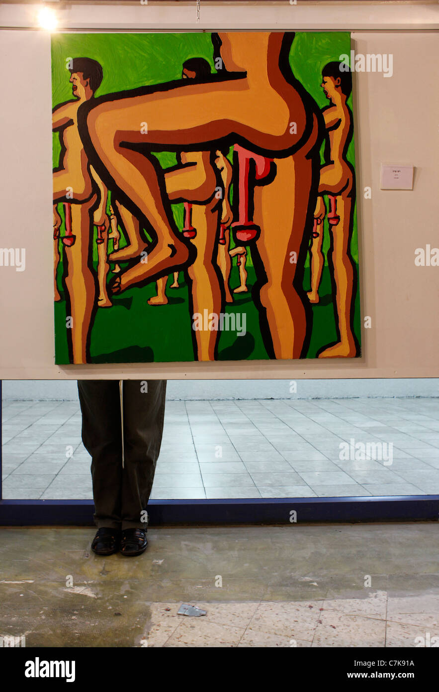 A visitor stands behind artwork by Israeli artist Rafi Peretz, displayed in a public space in Tel Aviv. Israel. 15 Israeli visual artists were selected for an exhibition entitled 'Protest'. They used the social protest that is taking place in Israel as inspiration for their artwork. Stock Photo