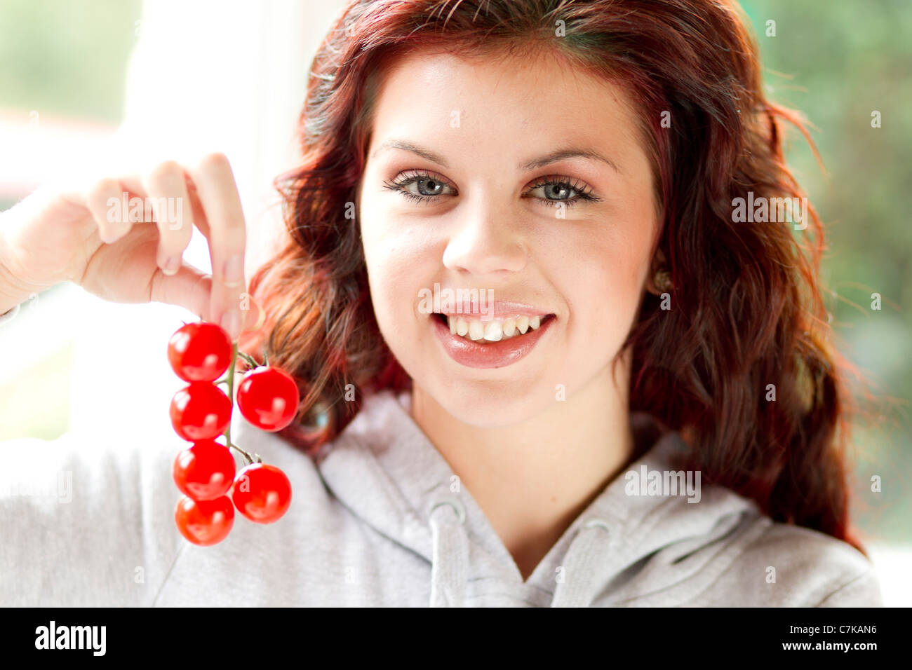 Woman holding cherry tomatoes Stock Photo - Alamy