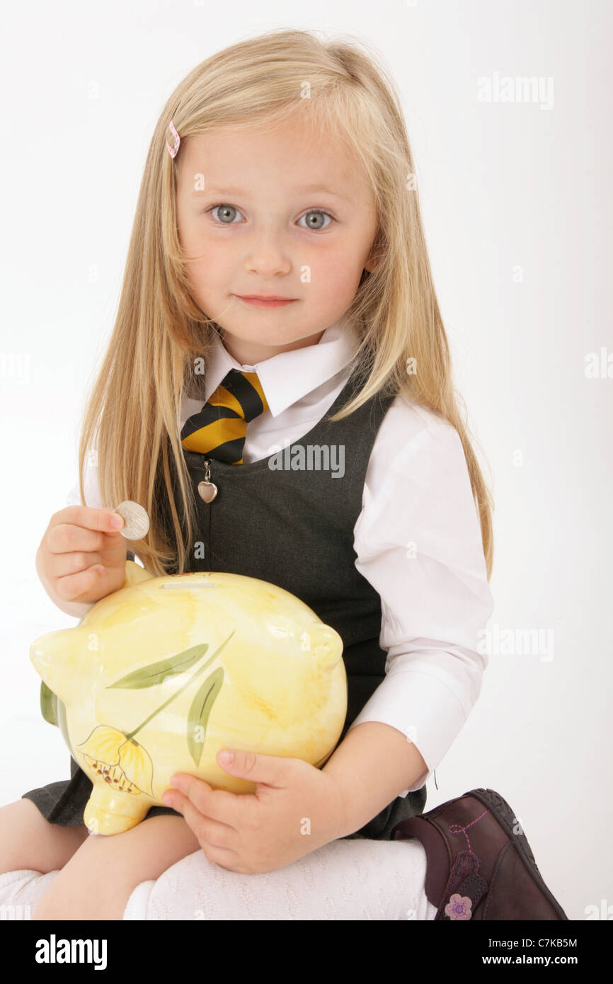 Young girl saving money in a piggy bank Stock Photo - Alamy