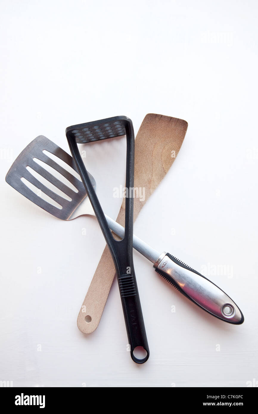 Three kitchen utensils against a white background - fish slice