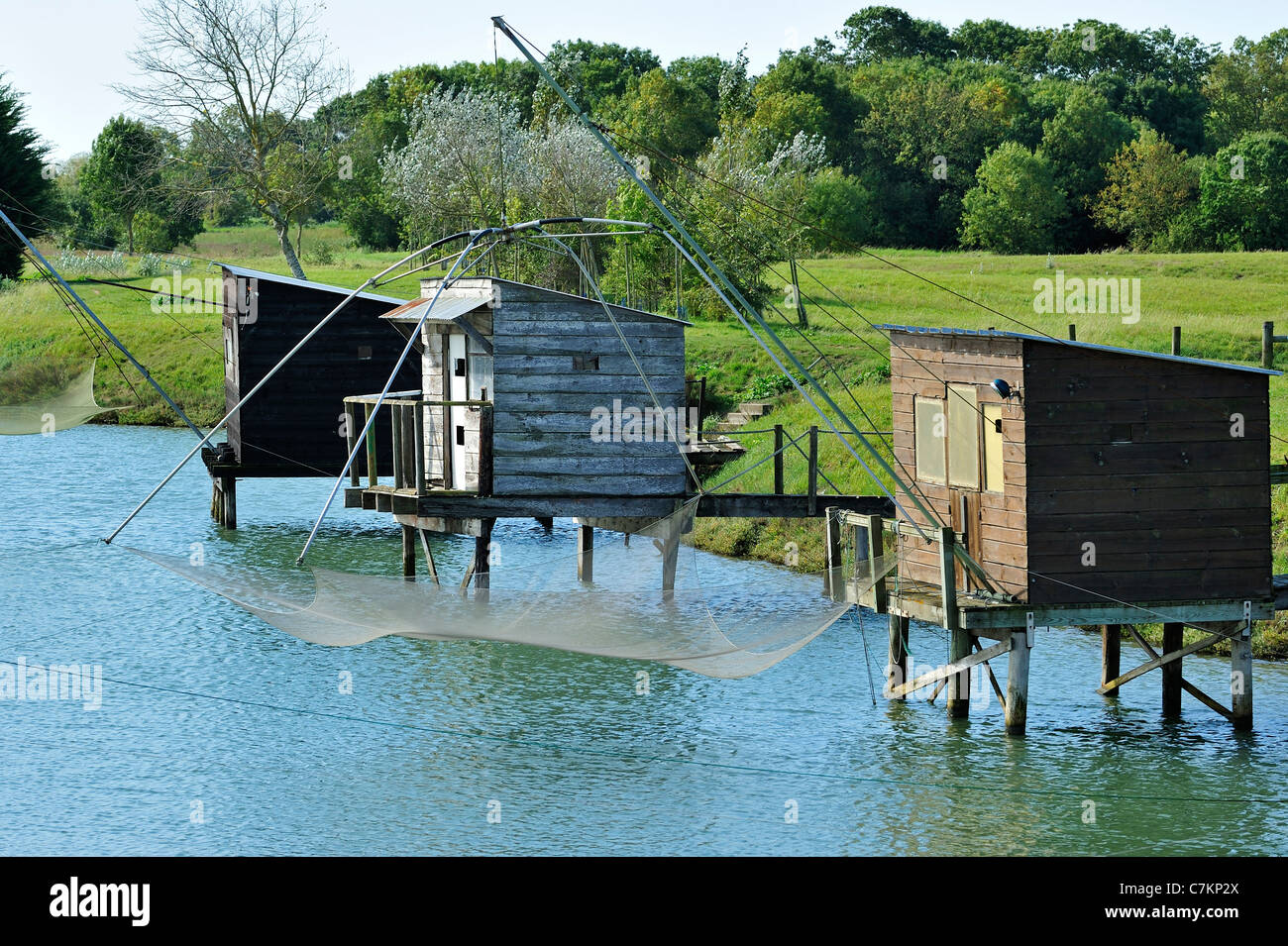 Traditional carrelet fishing huts with lift nets along river at La Vendée, Pays de la Loire, France Stock Photo