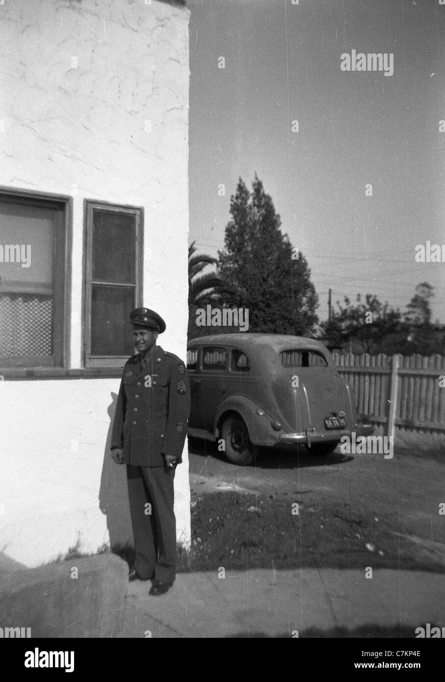 USA tech sargeant wwii car sgt male soldier military portrait outside house vertical Stock Photo