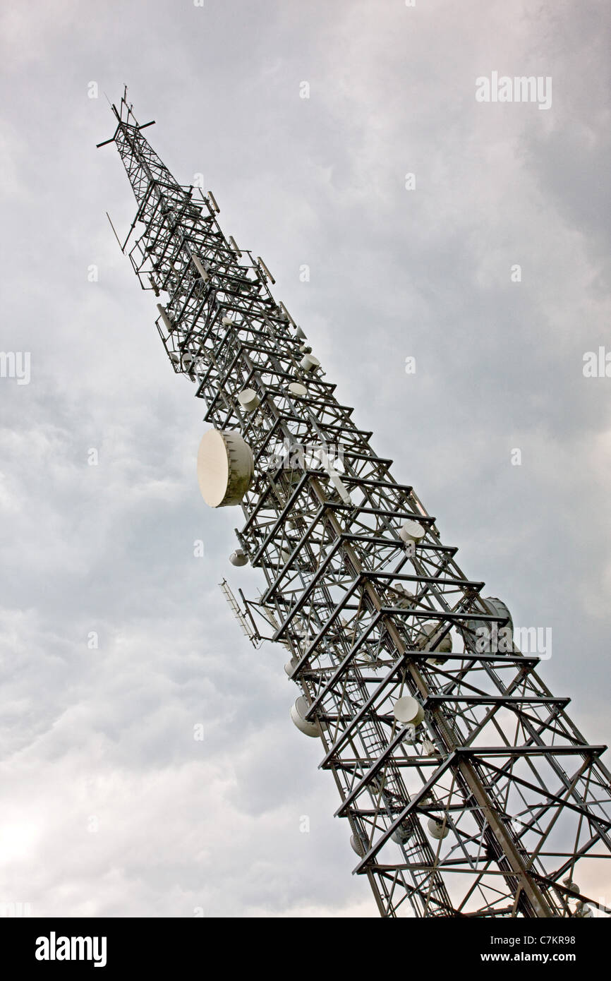 Steel communications mast with microwave drums and radio transmitter Stock Photo