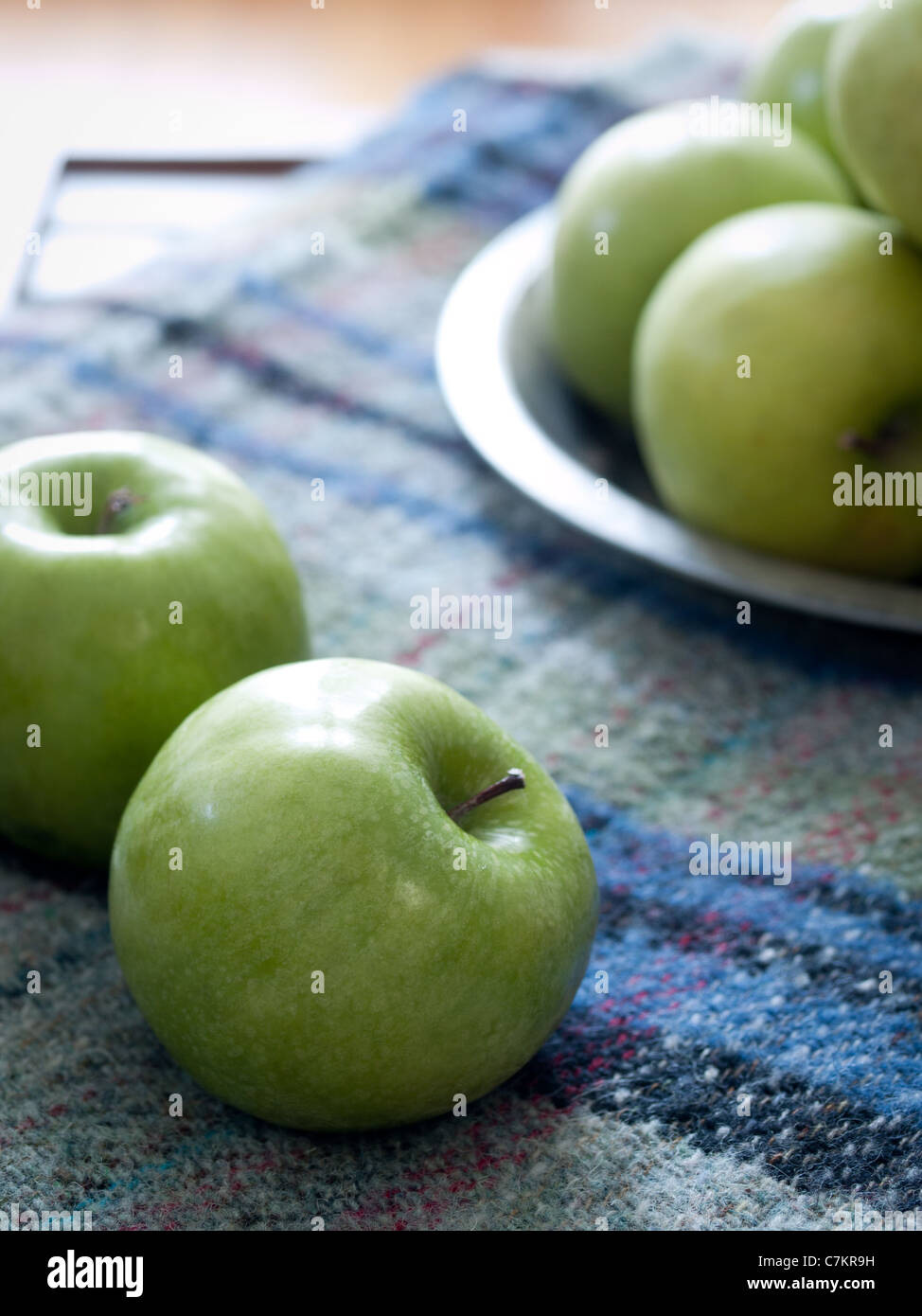 Granny smith apples sitting on a wool plaid blanket Stock Photo Alamy