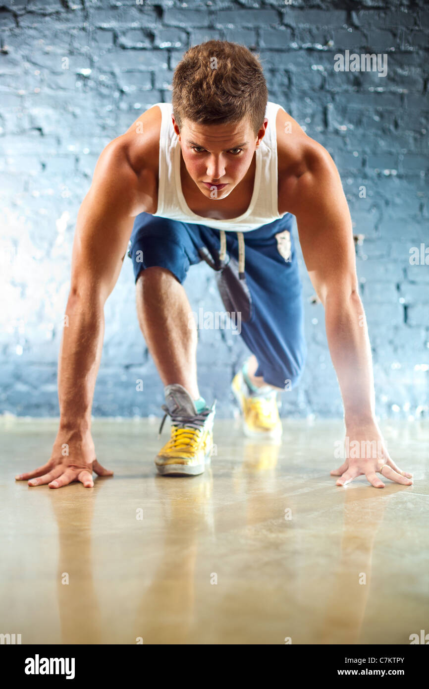Runner on start. Focus on face Stock Photo Alamy