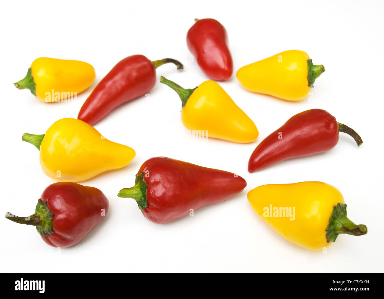 Lot of red and yellow peppers on a clear background Stock Photo - Alamy
