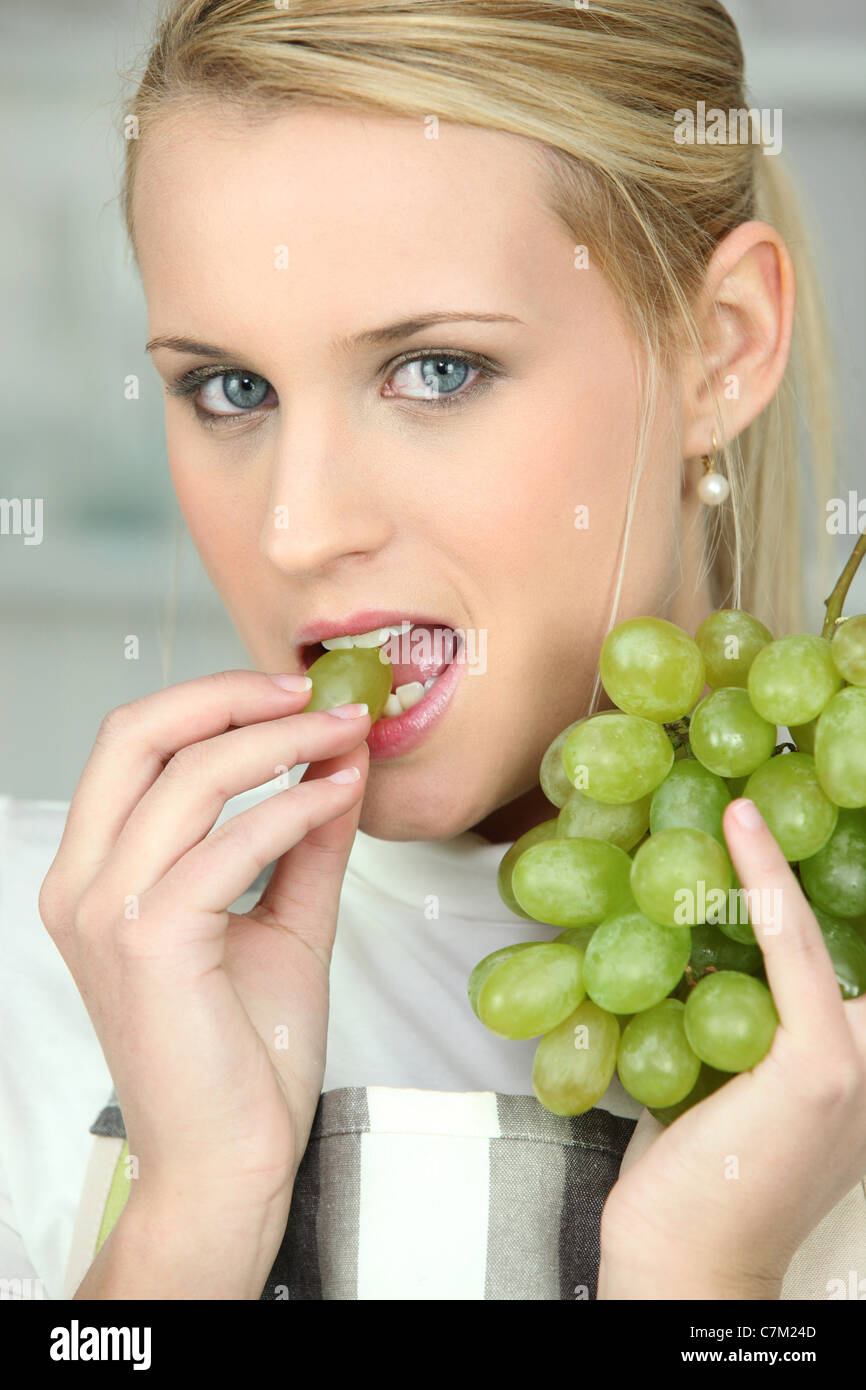Woman eating white grapes Stock Photo Alamy