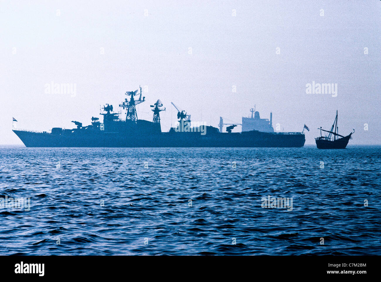 New and old naval vessel, cargo ship and a wooden Dhow in Arabian Sea