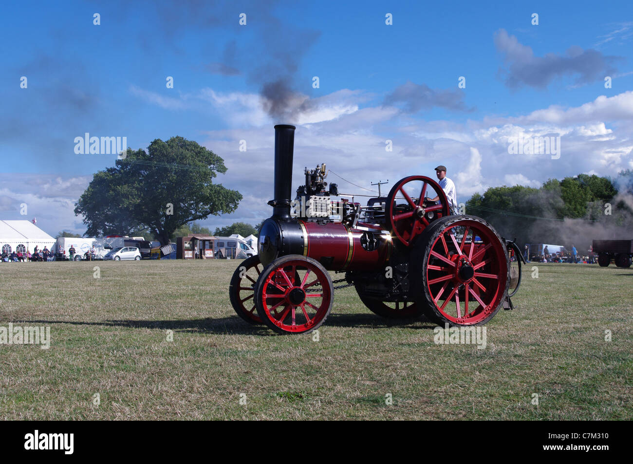 Garrett 1902 agricultural traction engine Lucy in steam at Stoke Prior Rally, left side. Sunny day, blue sky, white clouds Stock Photo