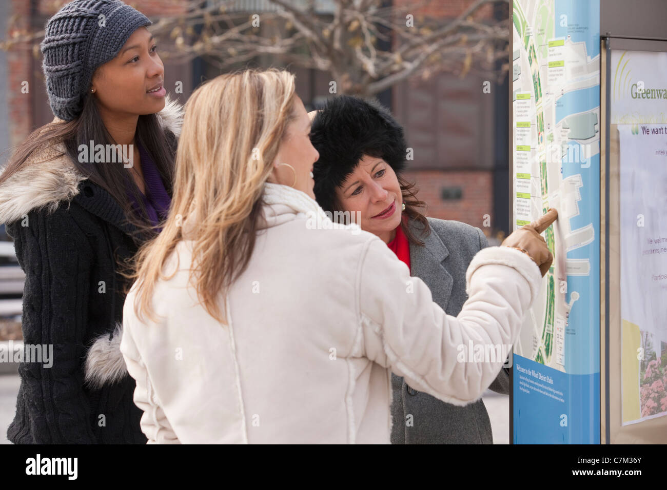 Women friends studying a park map Stock Photo