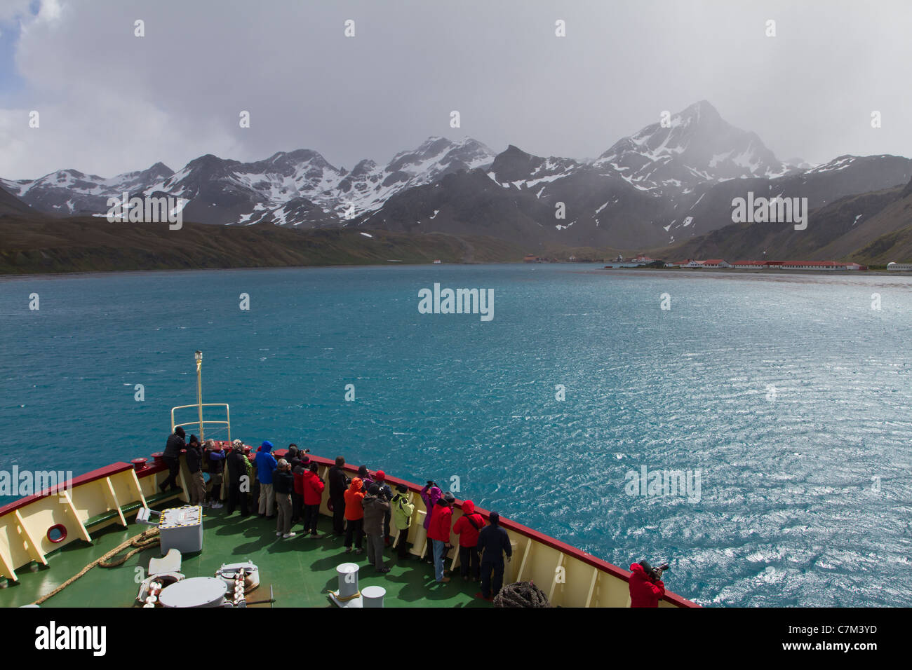A ship pulls into Cumberland Bay on a windy day at South Georgia Island. Stock Photo