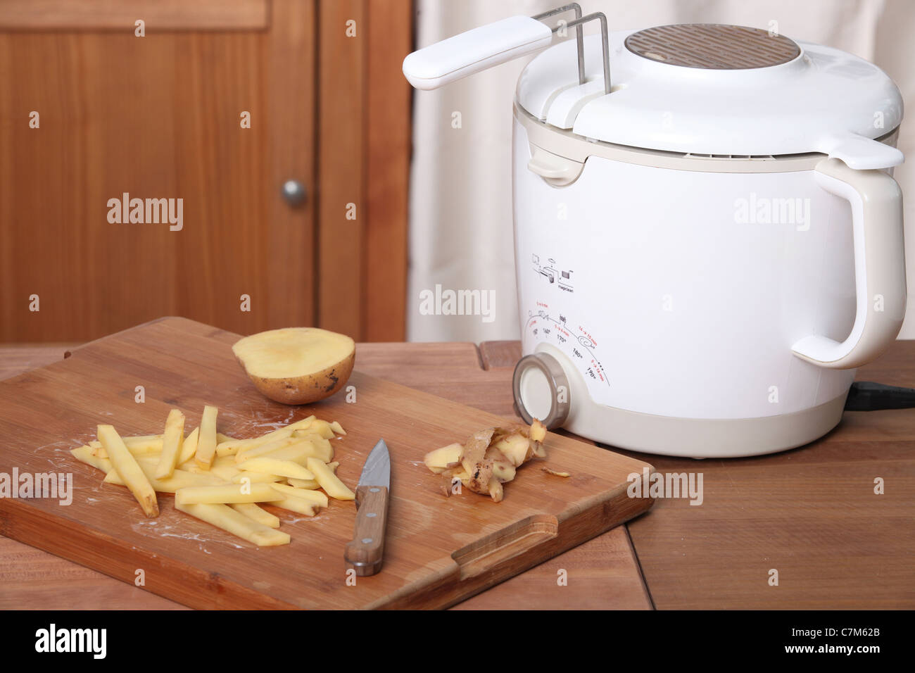 Making chips with a deep fat fryer Stock Photo Alamy
