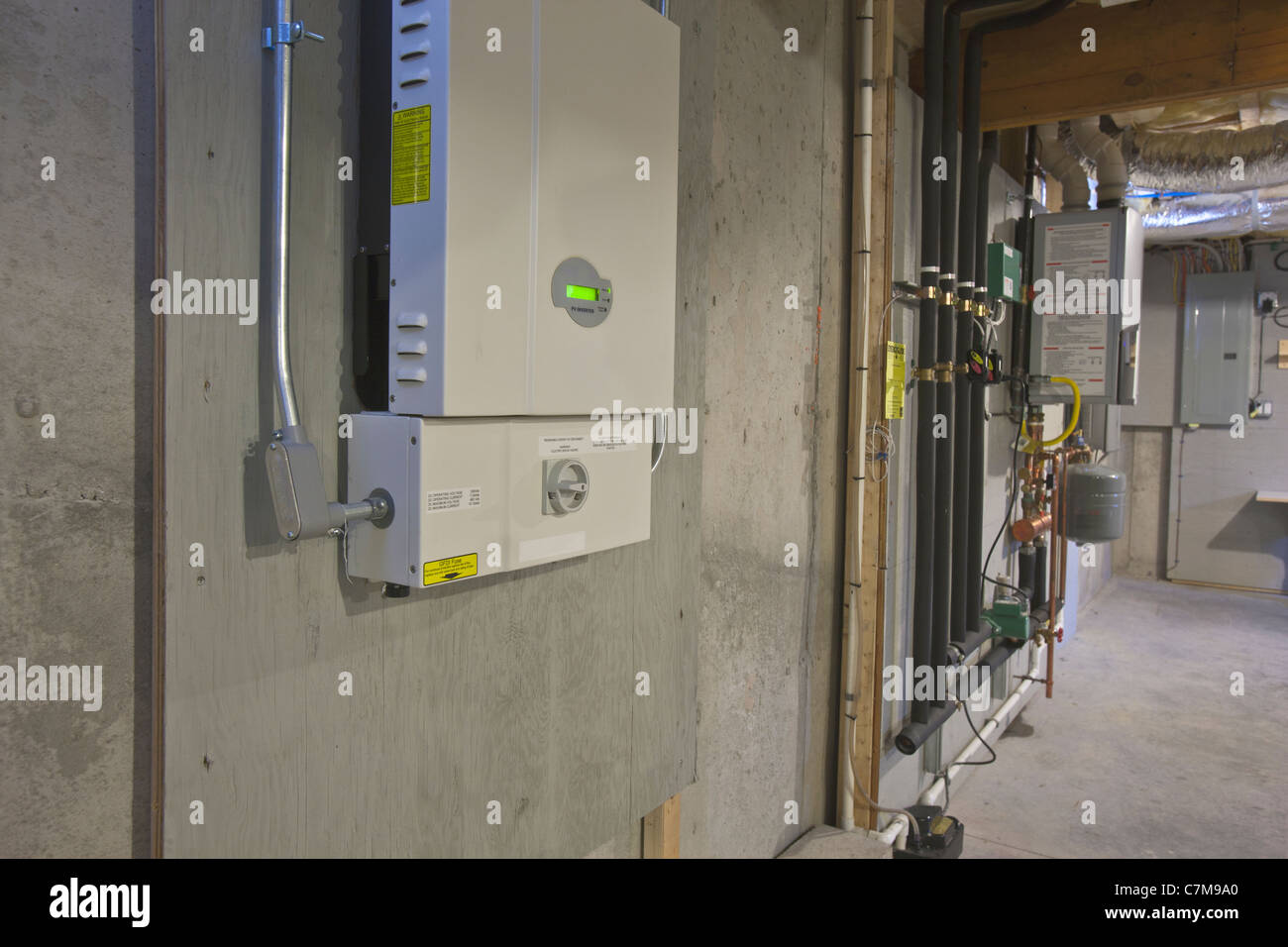 Photovoltaic inverter and transfer switch in the basement of a Green Technology Home Stock Photo