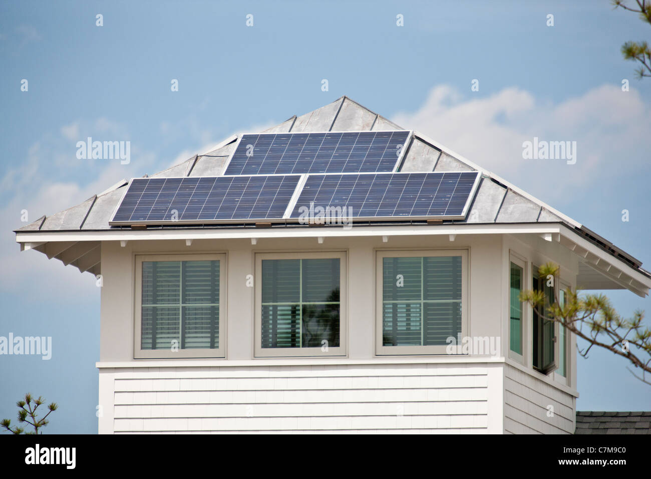 Solar electric power panels on roof of Green Technology Home Stock Photo