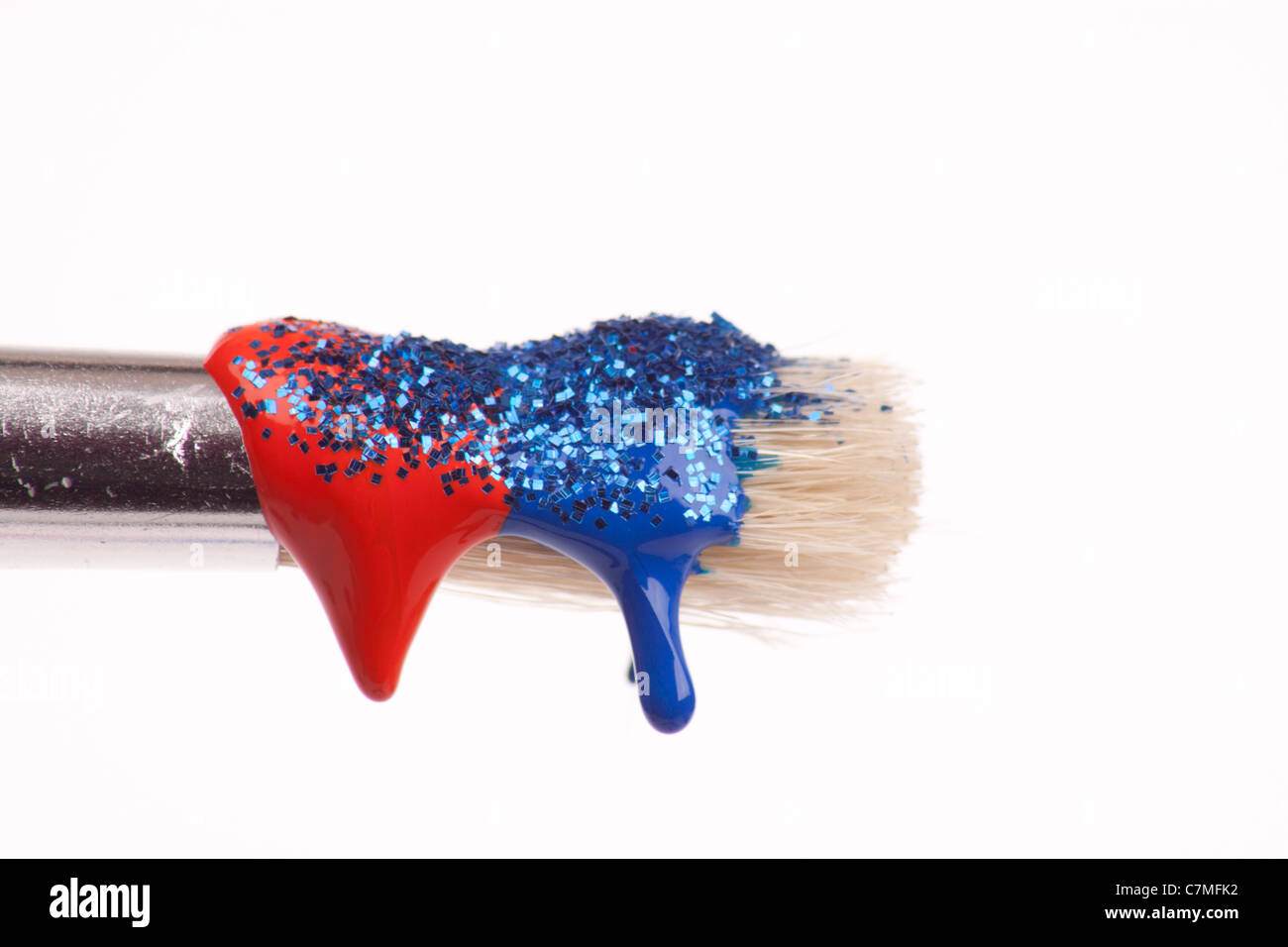 paint brush dripping with different coloured paints Stock Photo Alamy