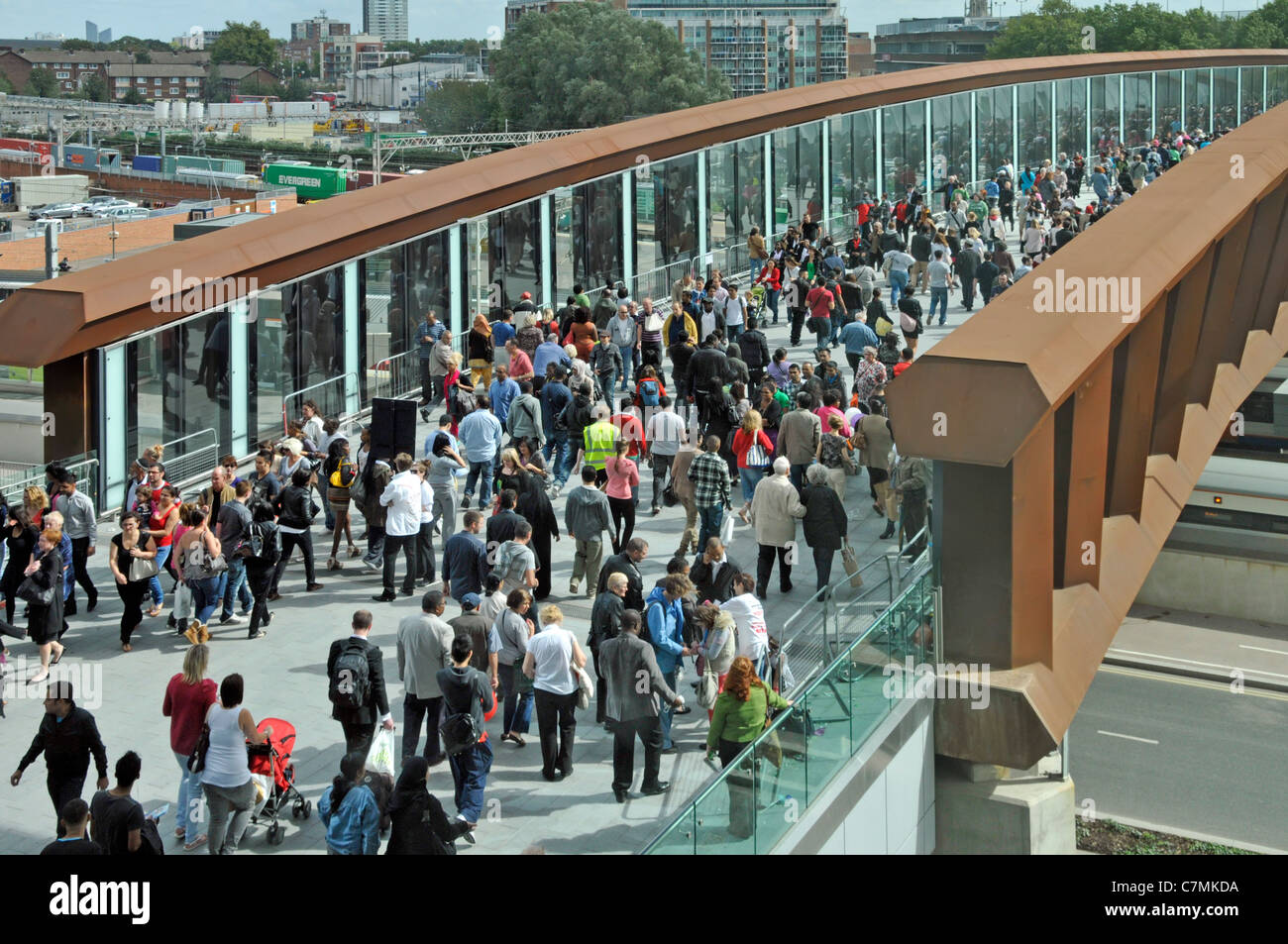 Crowd of people shoppers on railway footbridge & access link from Stratford town walking above train station at Westfield Shopping Centre East London Stock Photo