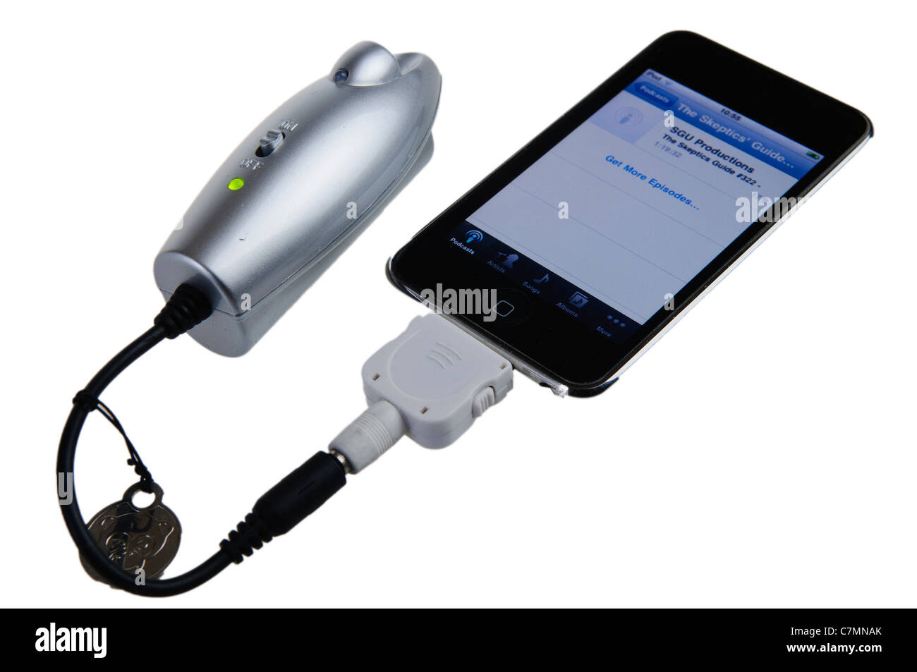 Powermonkey portable charger charging an Apple iPod/iPhone Stock Photo