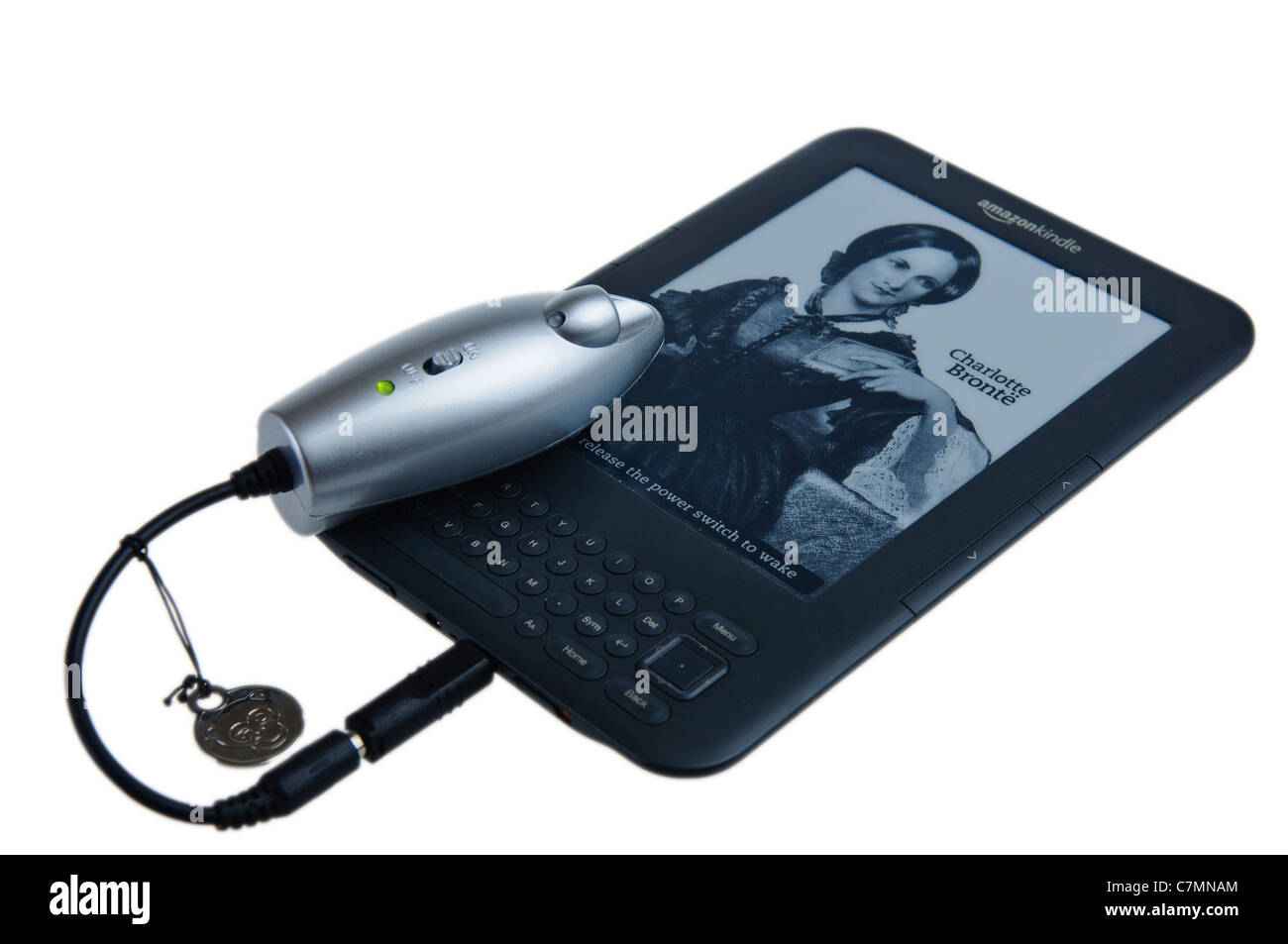 Powermonkey portable charger charging an Amazon Kindle Stock Photo