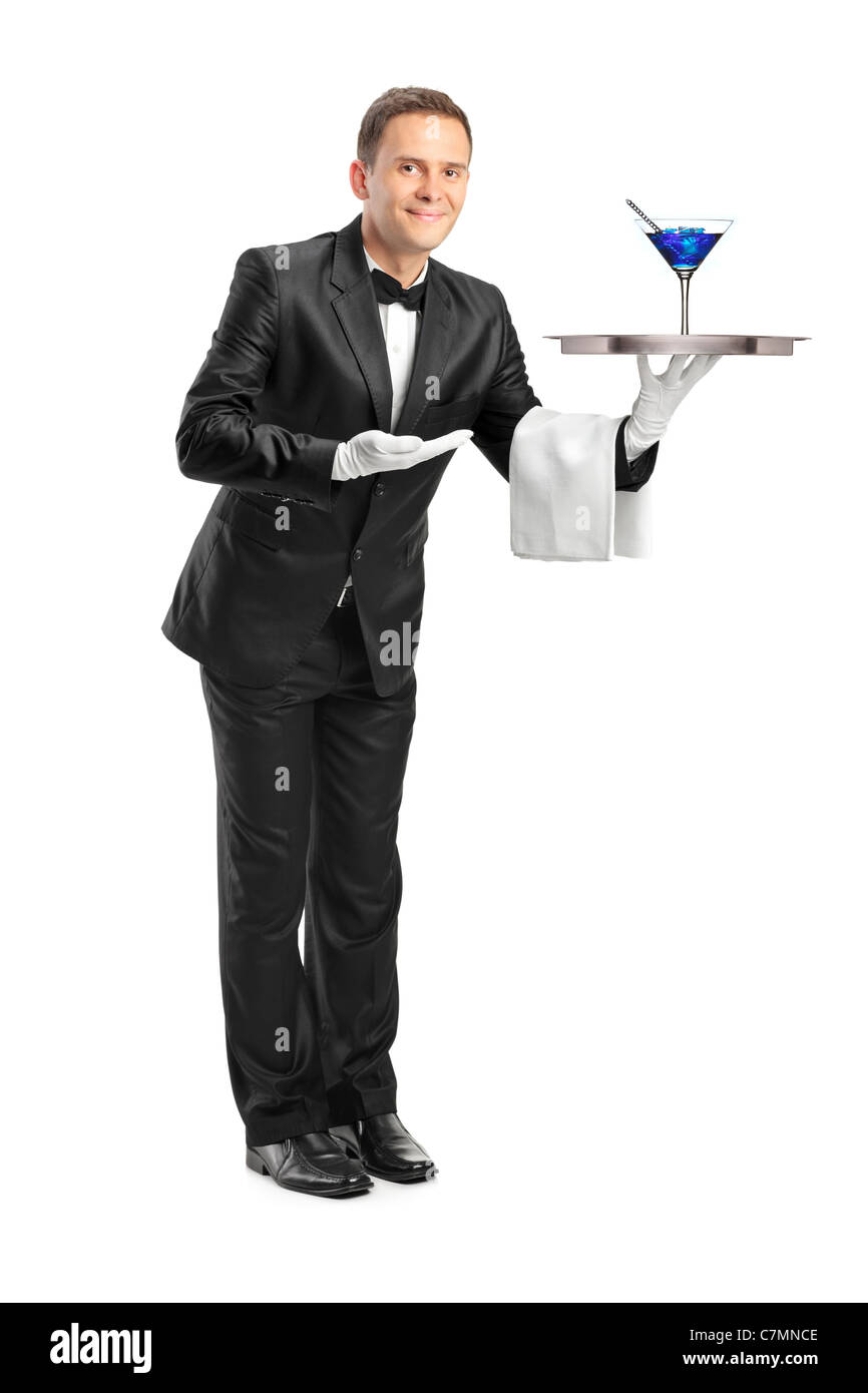 Full length portrait of a butler with bow tie carrying a tray with a cocktail on it Stock Photo