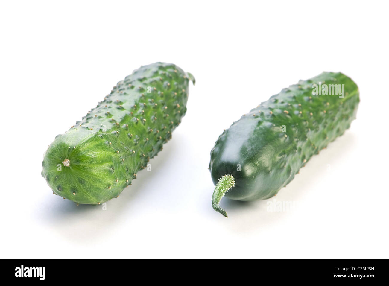 Green long cucumber fresh vegetable isolated on white Stock Photo