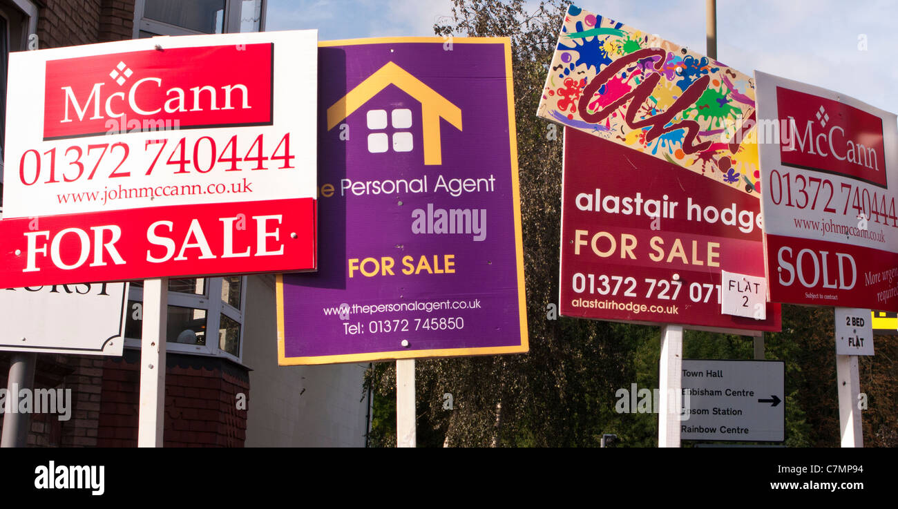 Estate agents' 'For Sale' boards, Surrey, UK Stock Photo