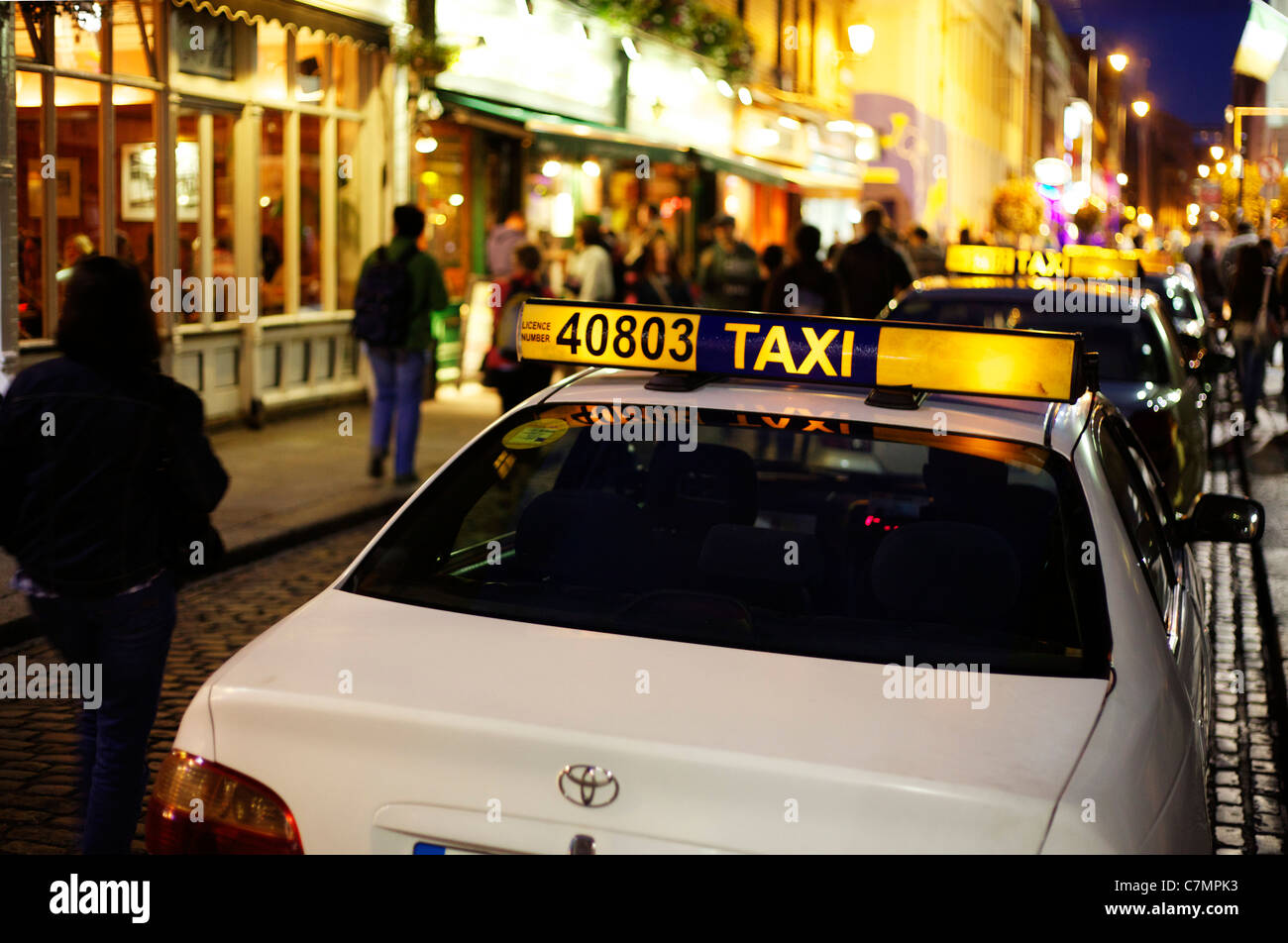 Taxis in line at night at Temple Bar, Dublin, Ireland Stock Photo