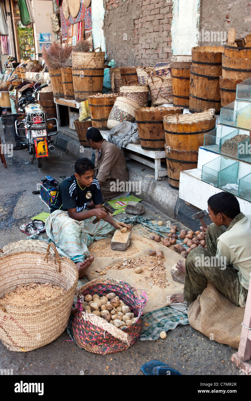 Egyptian boys crushing spices - Aswan, Upper Egypt Stock Photo