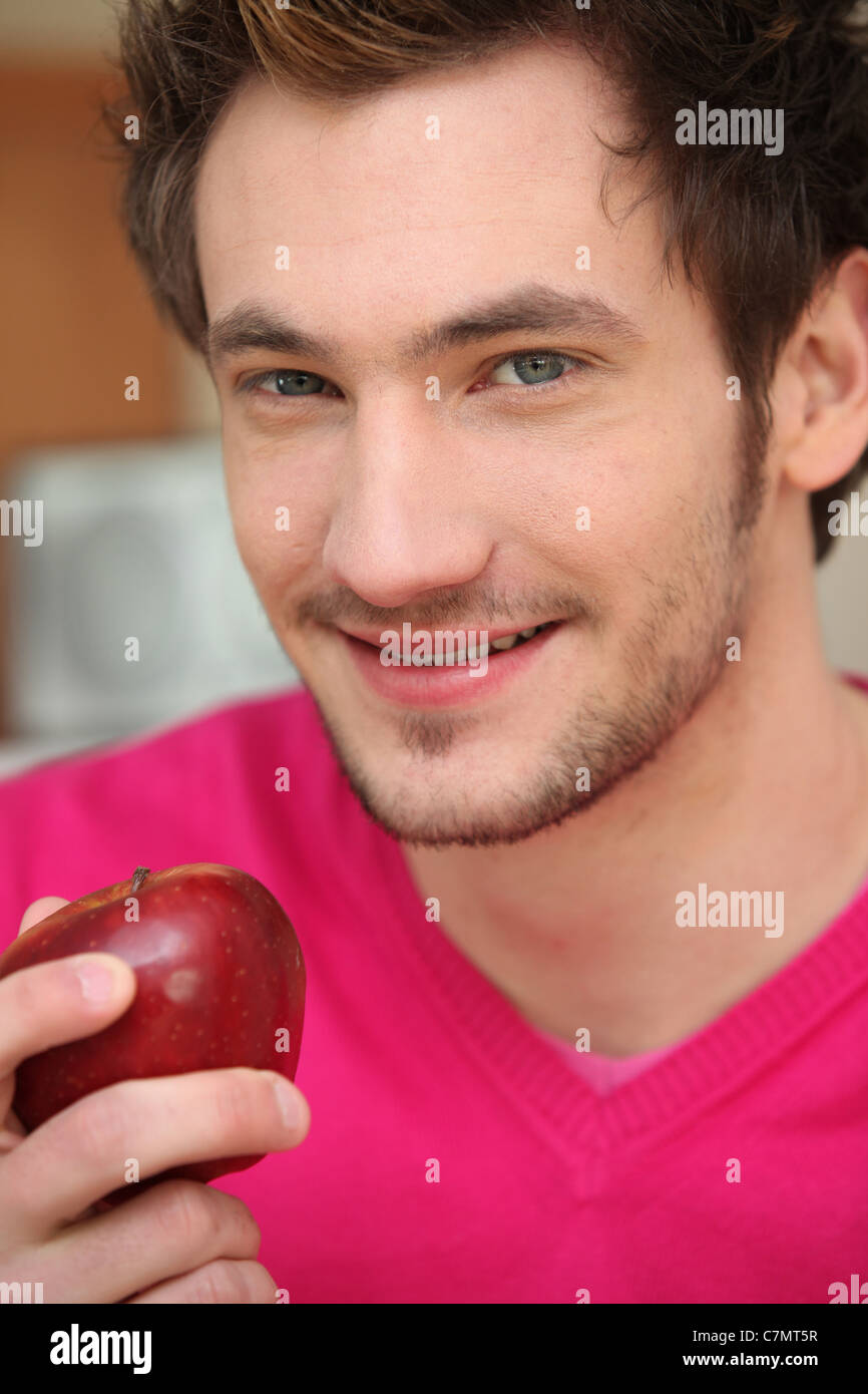 Young man with a red apple Stock Photo - Alamy