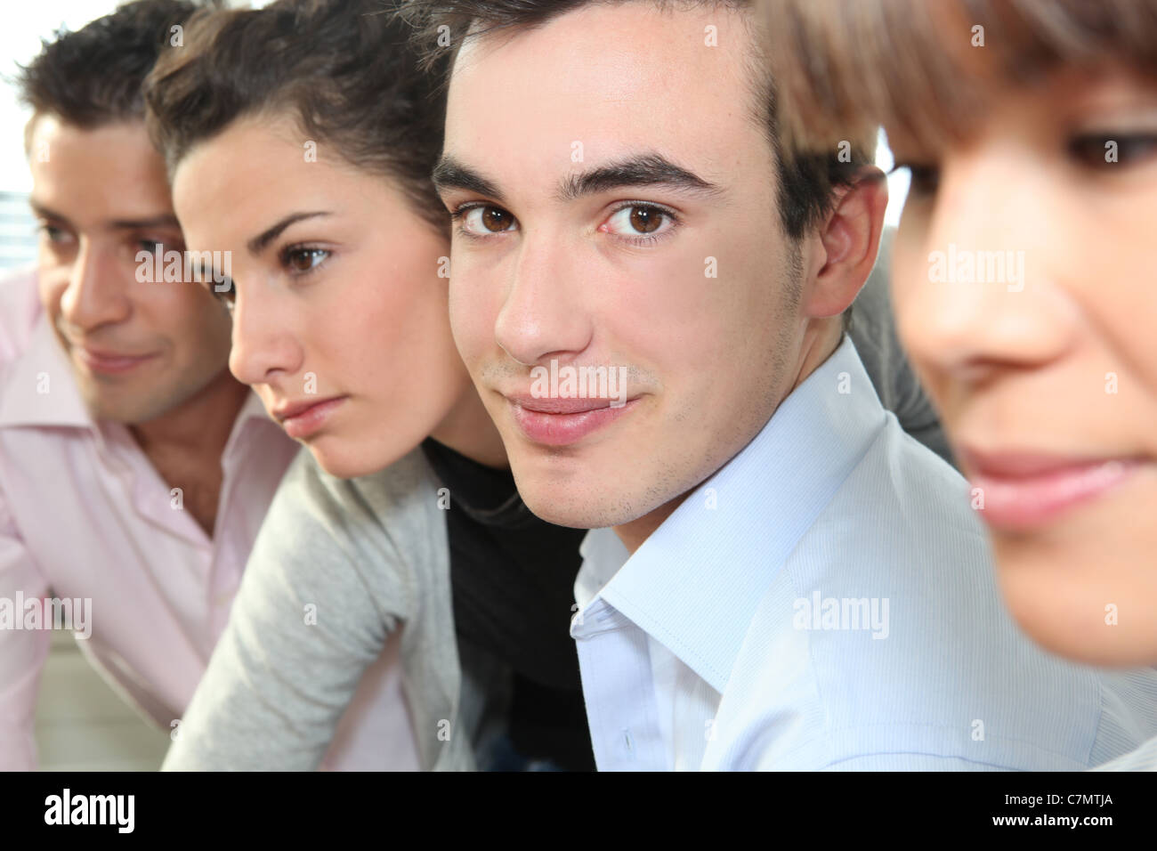 Closeup of people's faces in an office Stock Photo