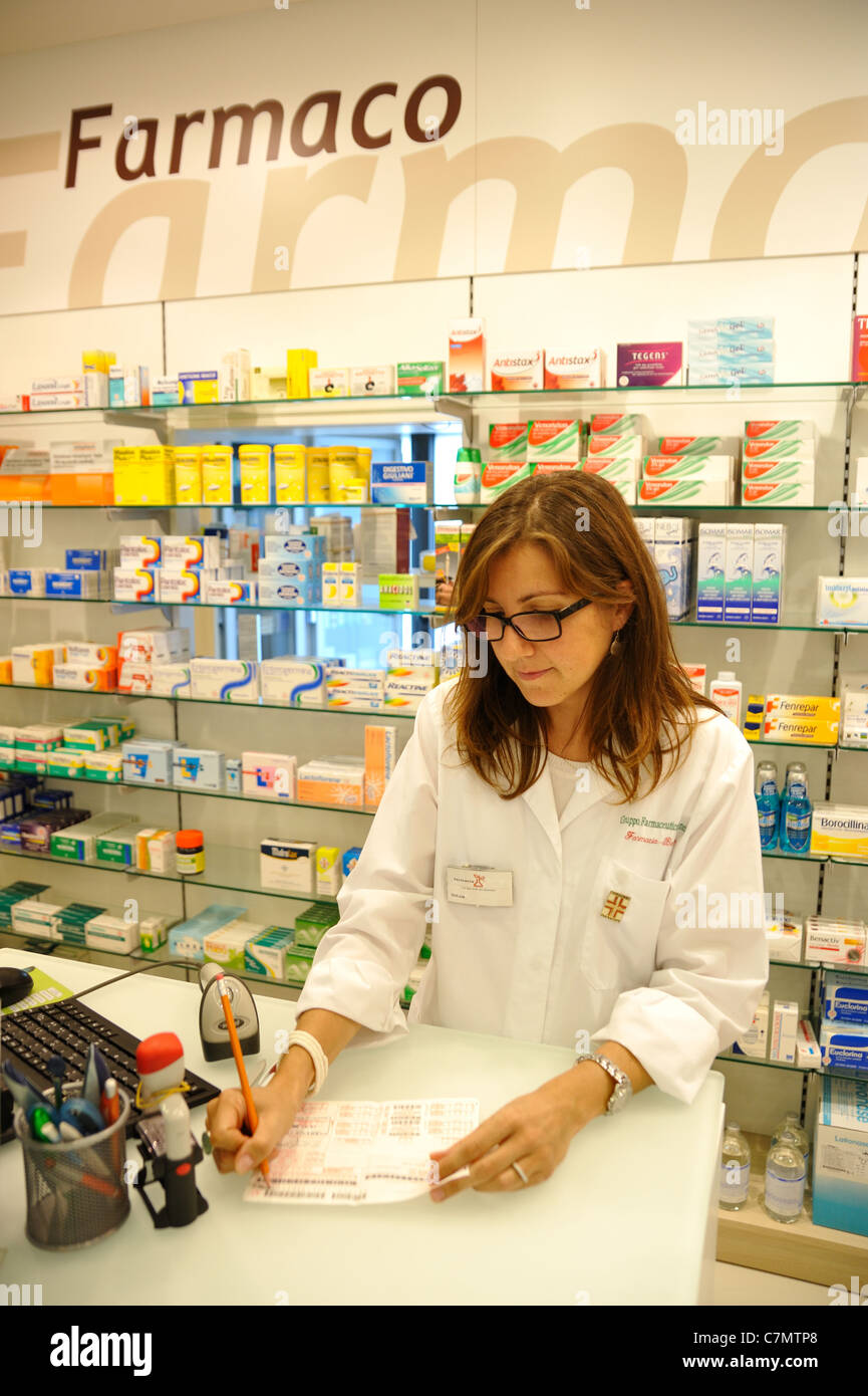 Pharmacist standing in pharmacy (give prescription) Stock Photo